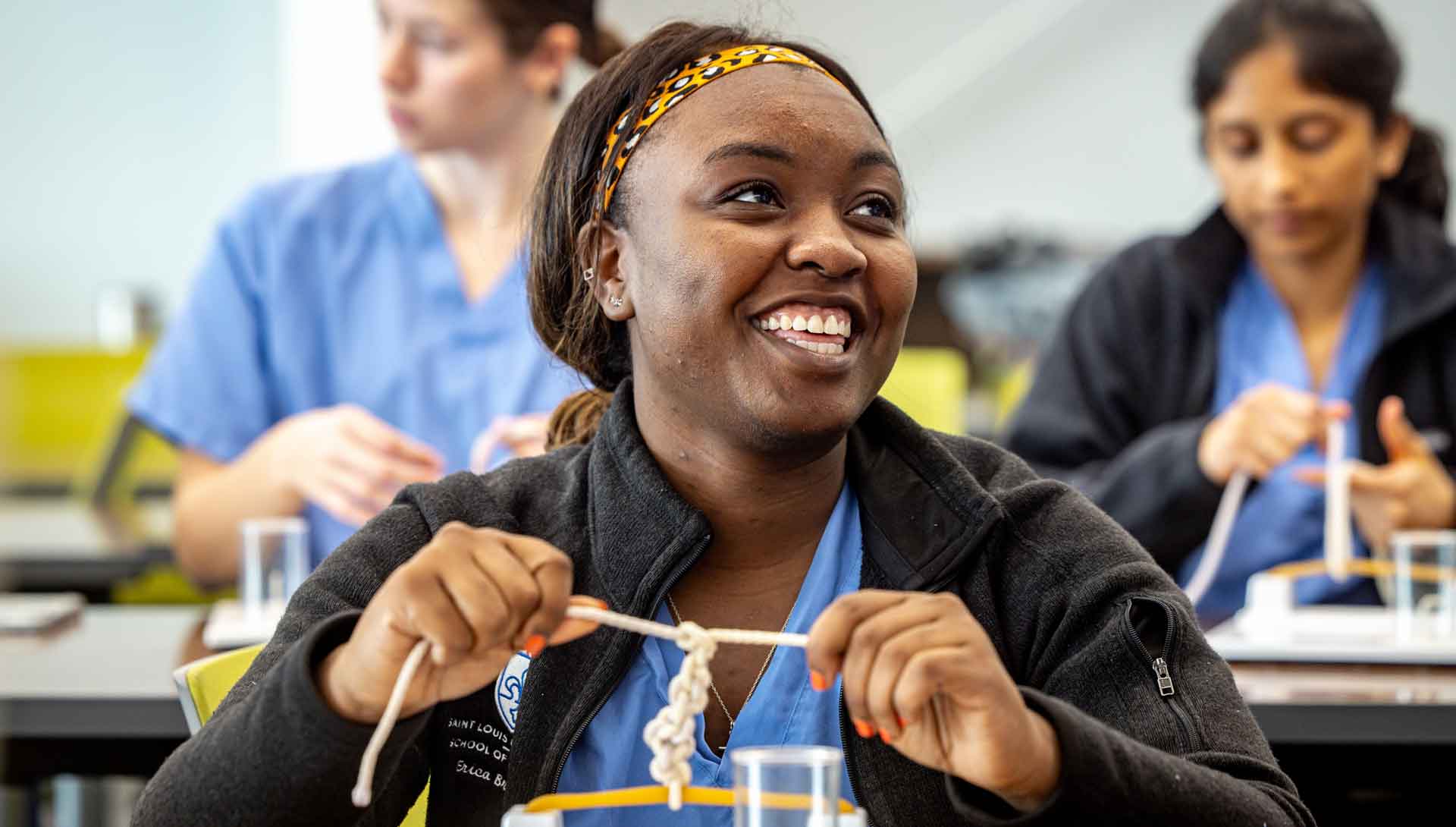 Students practice medical suturing in a lab setting