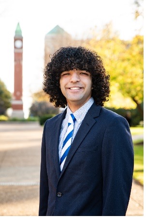 Antonio Donohue stands in front of the SLU clock tower