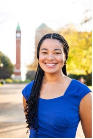 Rebecca Townley stands in front of the SLU clock tower