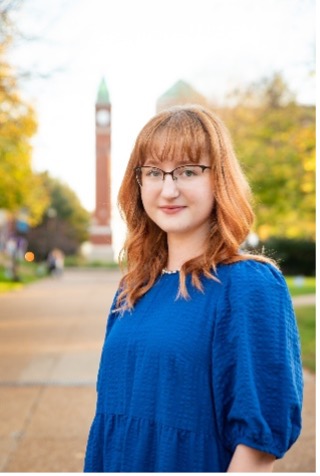 Amanda VanNierop stands in front of the SLU clock tower