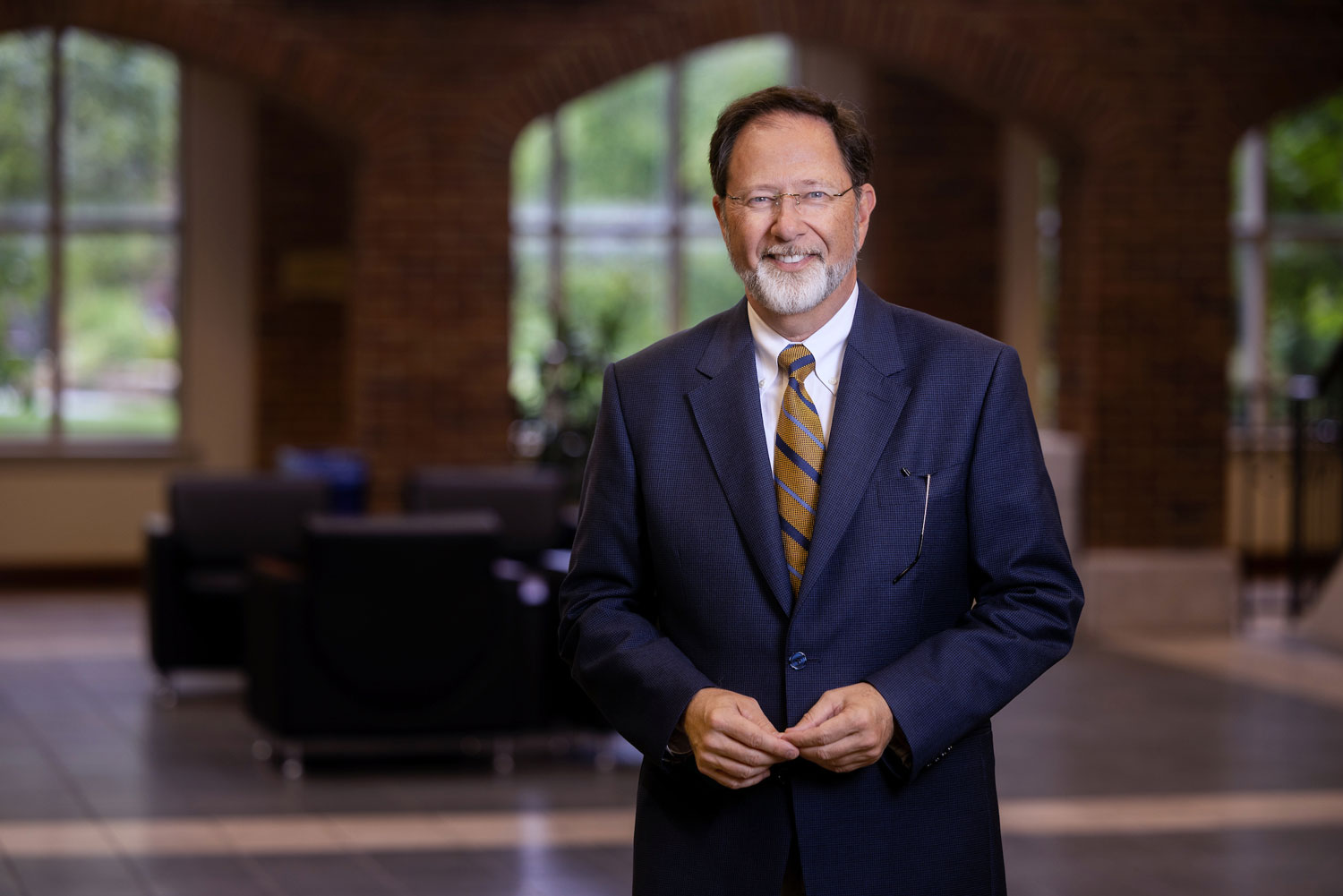 Jackson Nickerson, Ph.D., Edward Jones Dean of the Chaifetz School of Business poses on the staircase of Cook Hall.