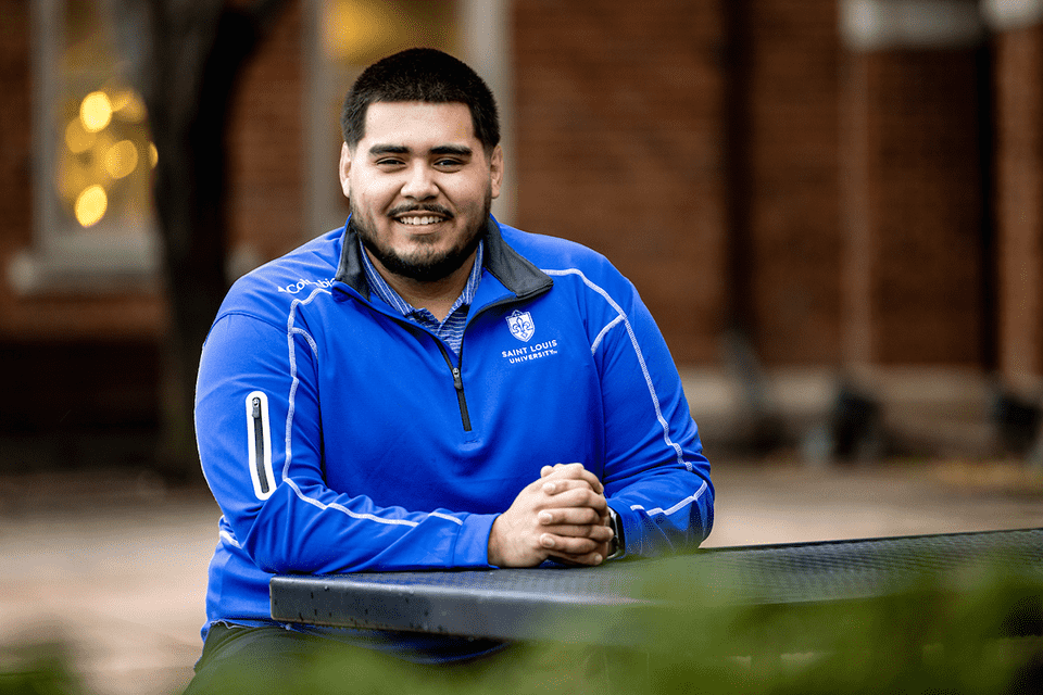 Gael Cosgaya sits at a table at the School of Business