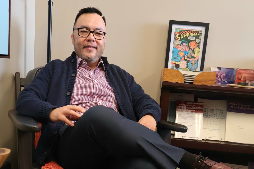 Jeremiah Ho sits in his office at Scott Hall