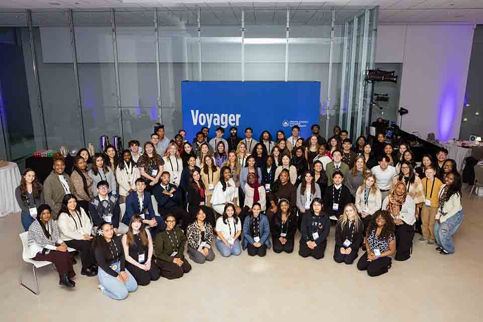 a group of people sit in a semi-circle