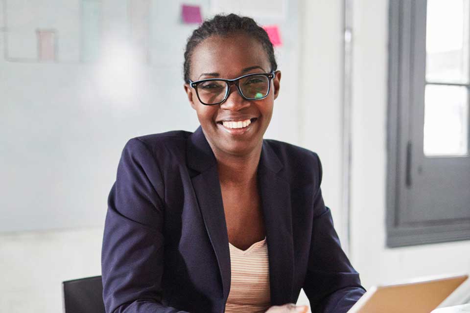 Women with laptop smiling at camera