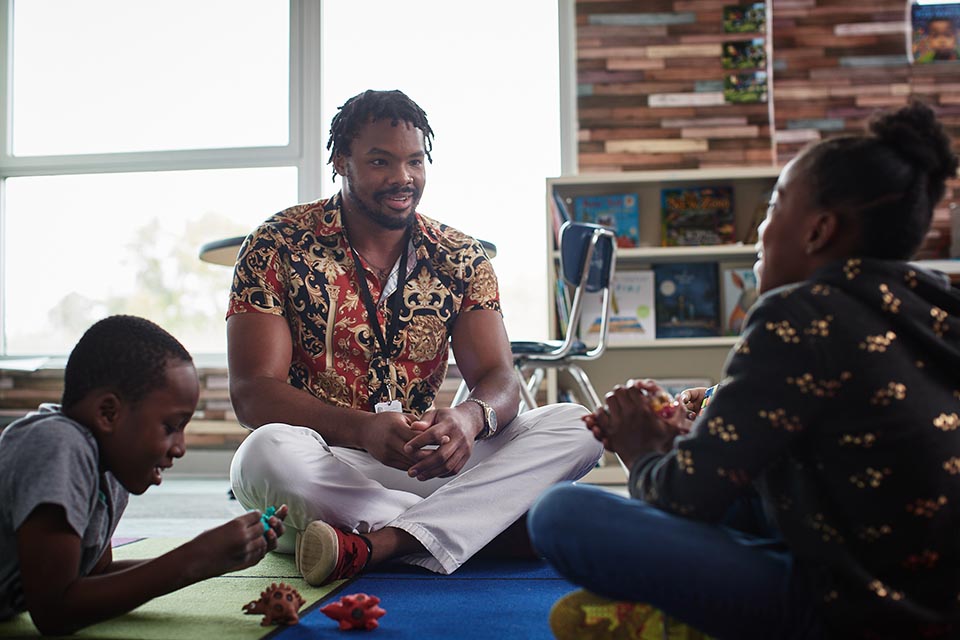 Man sitting on floor with children