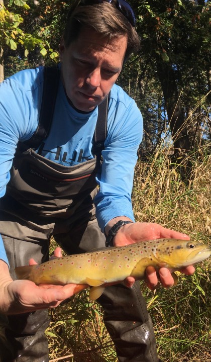 Jason Knouft, Ph.D. Jason Knouft, Ph.D., holds a fish while researching in an aquatic ecosystem