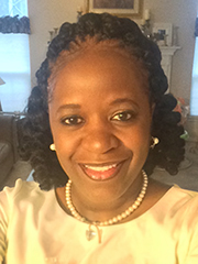 Smiling woman in a cream colored dress blouse