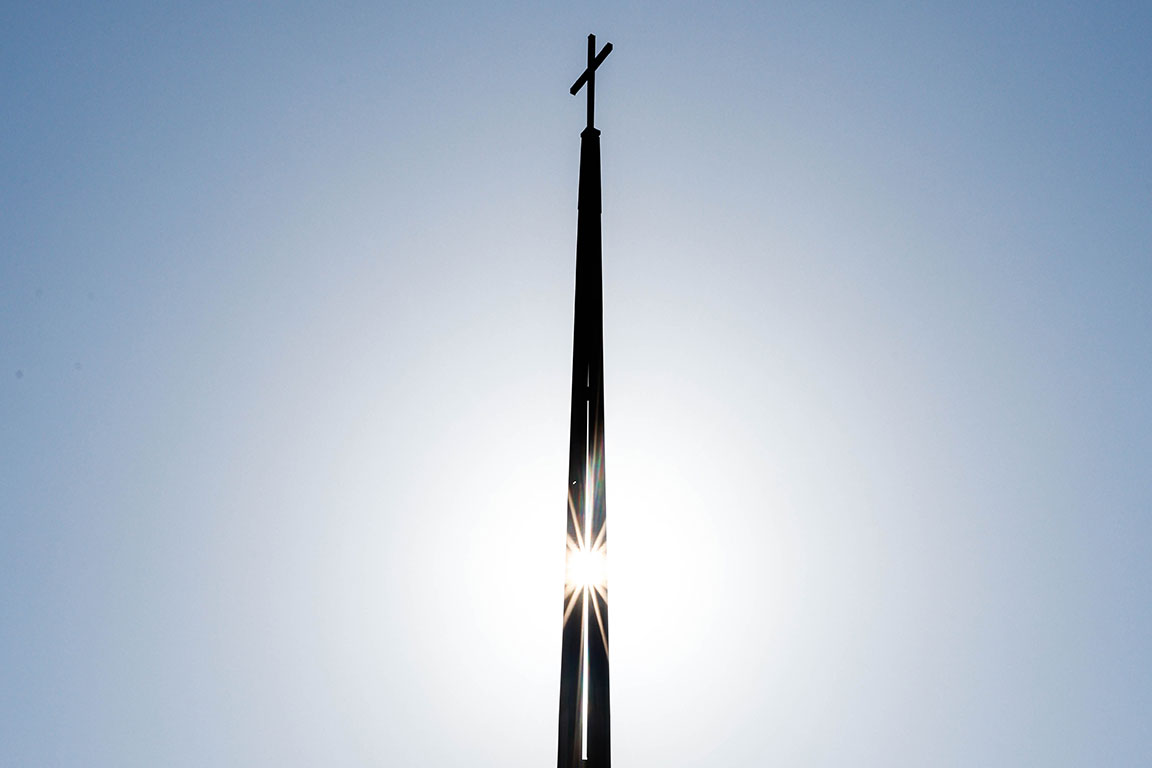 Sun shines through the steeple on the chapel of SLU's Jesuit Center